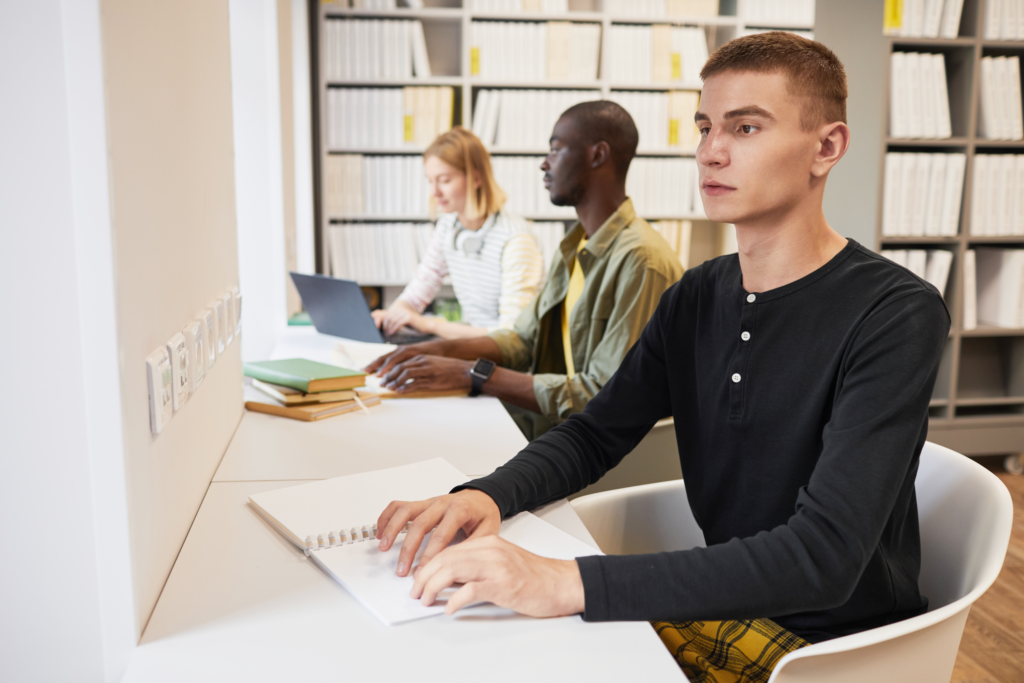 Image of a blind student in a library
