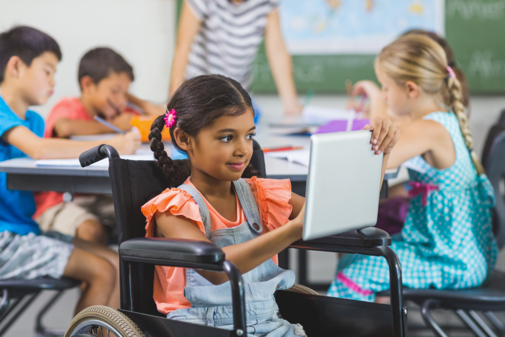 Disabled schoolgirl using a digital tablet
